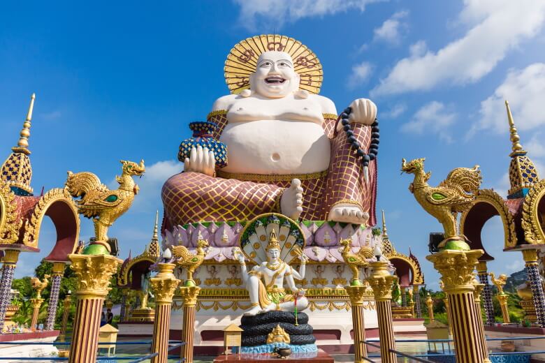 Budai and the buddha at Wat Plai Laem Temple in the Samui island, Thailand