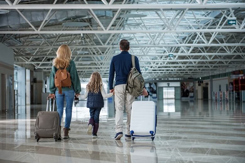 Family in an airport moving abroad